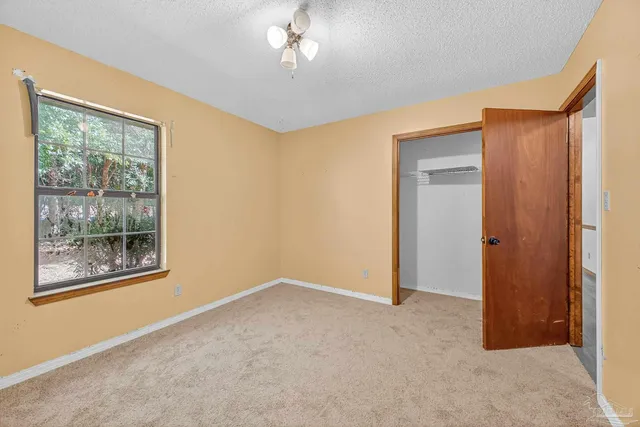 an empty room with a empty space and windows