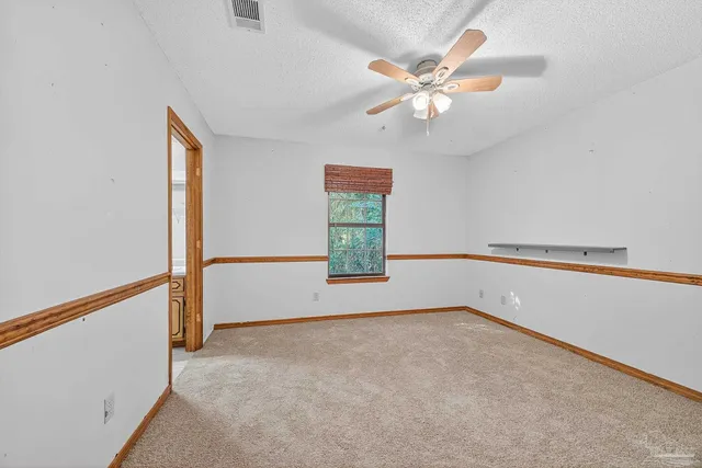 a view of room with window and ceiling fan