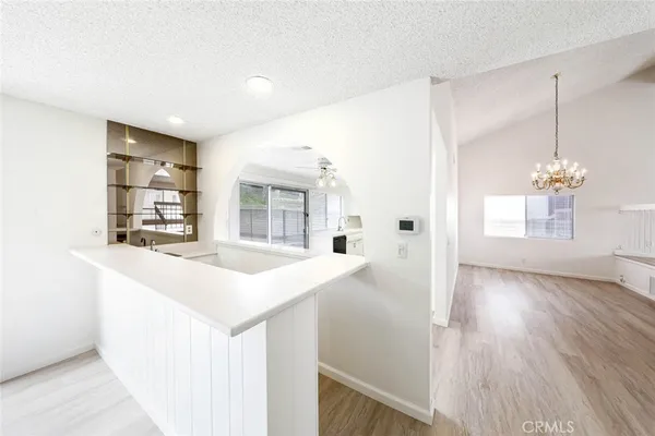a kitchen with a sink and chandelier