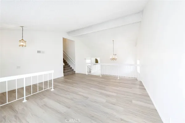 a view of a room with wooden floor and window