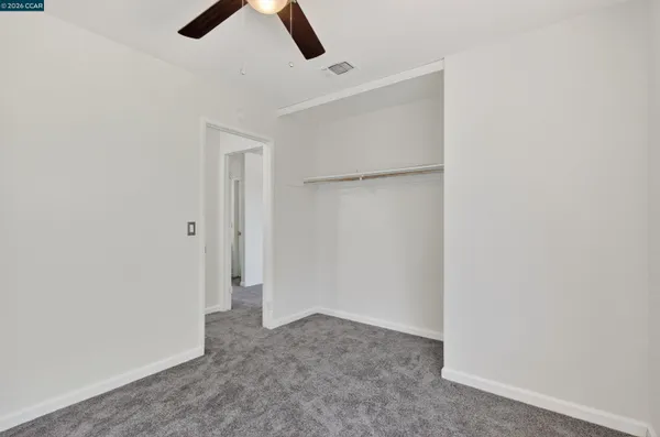 a work room with furniture and a ceiling fan