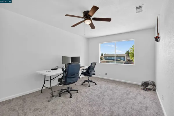 a view of a room with a ceiling fan