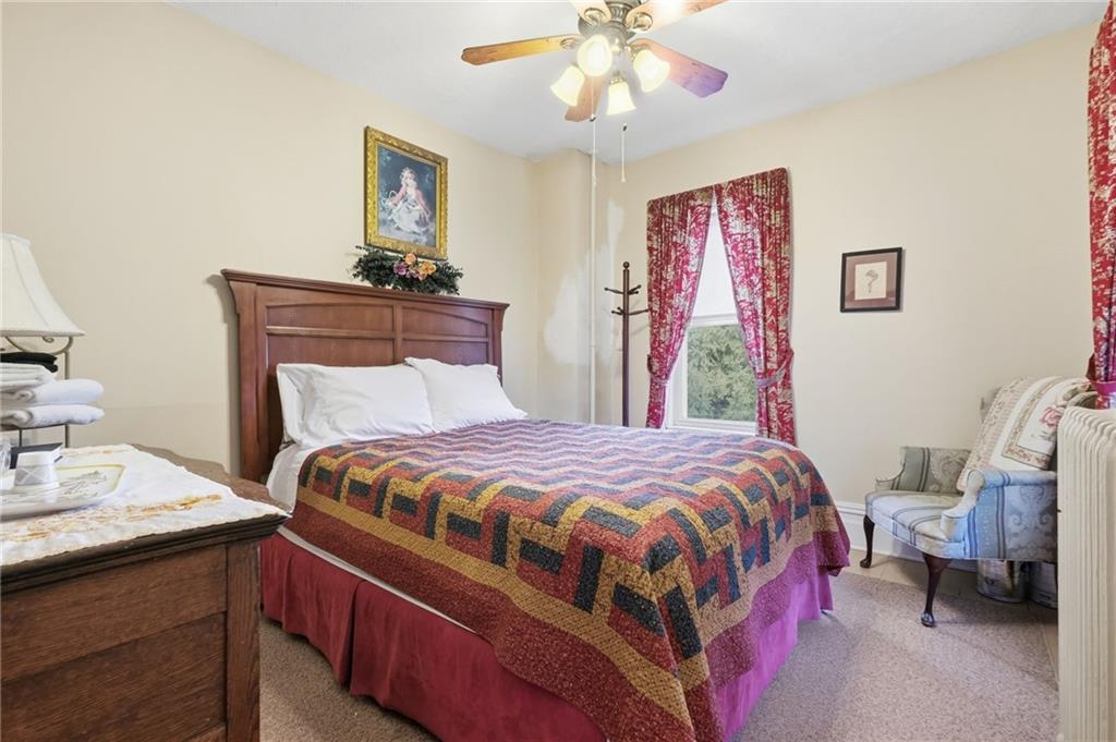 156 Rockdale Road Rockwood, PA 15557 - Photo 22 of 35 a bedroom with a bed and a chandelier