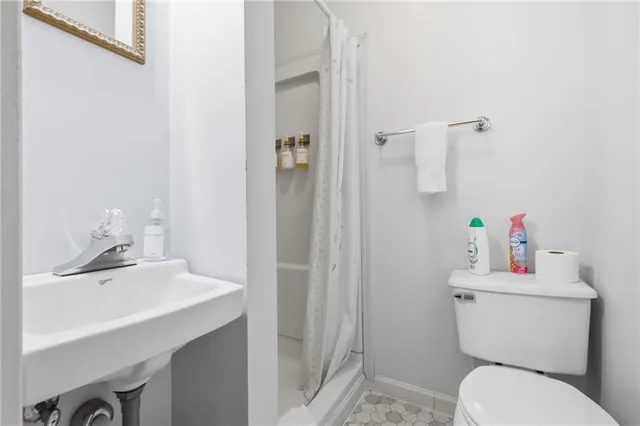 a bathroom with a sink toilet and a mirror