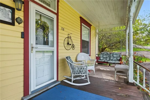 a view of a porch with chairs and backyard