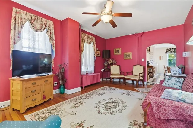 a living room with furniture a flat screen tv and a dresser