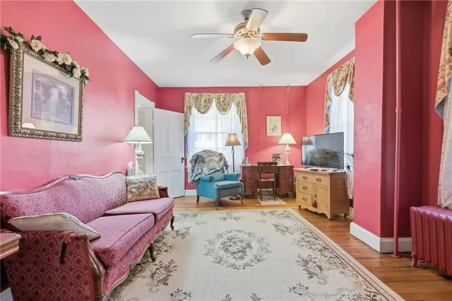 a living room with furniture a large window with wooden floor