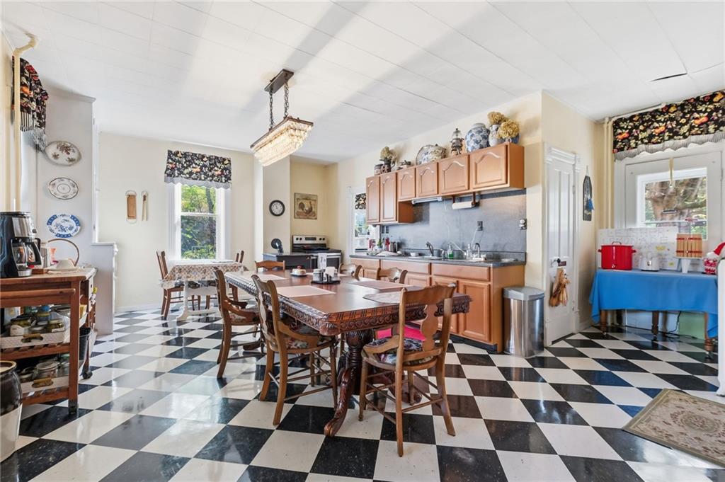 156 Rockdale Road Rockwood, PA 15557 - Photo 10 of 35 a kitchen with a checkered floor and dining table with a black white checkered floor
