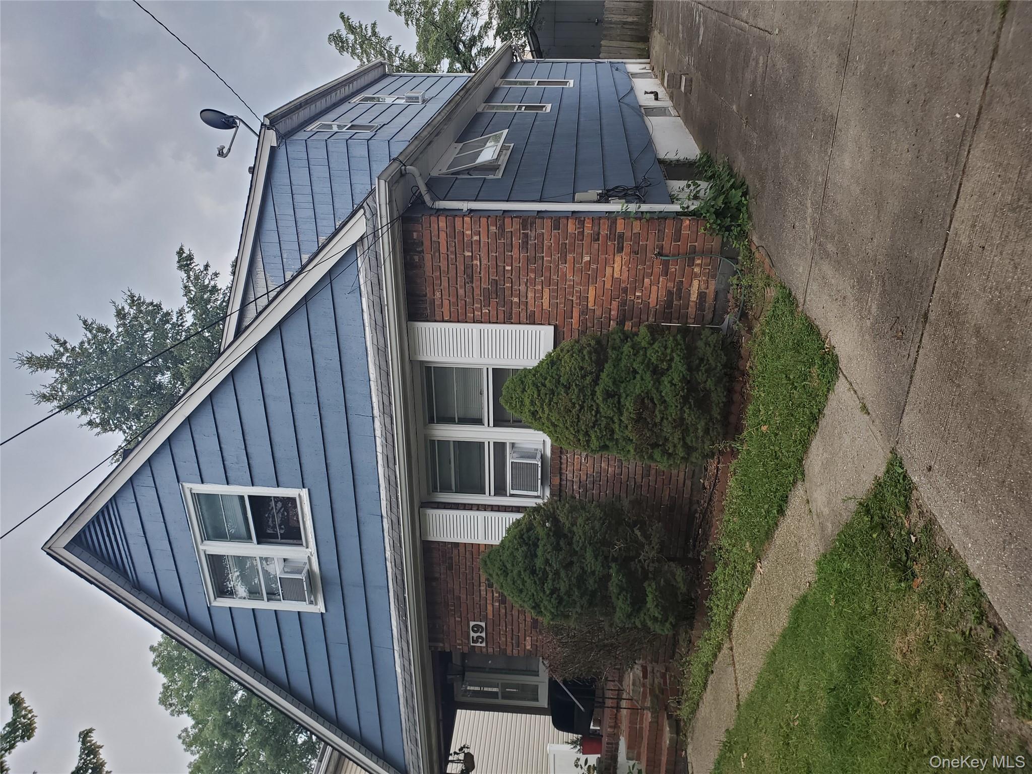 View of property exterior featuring brick siding