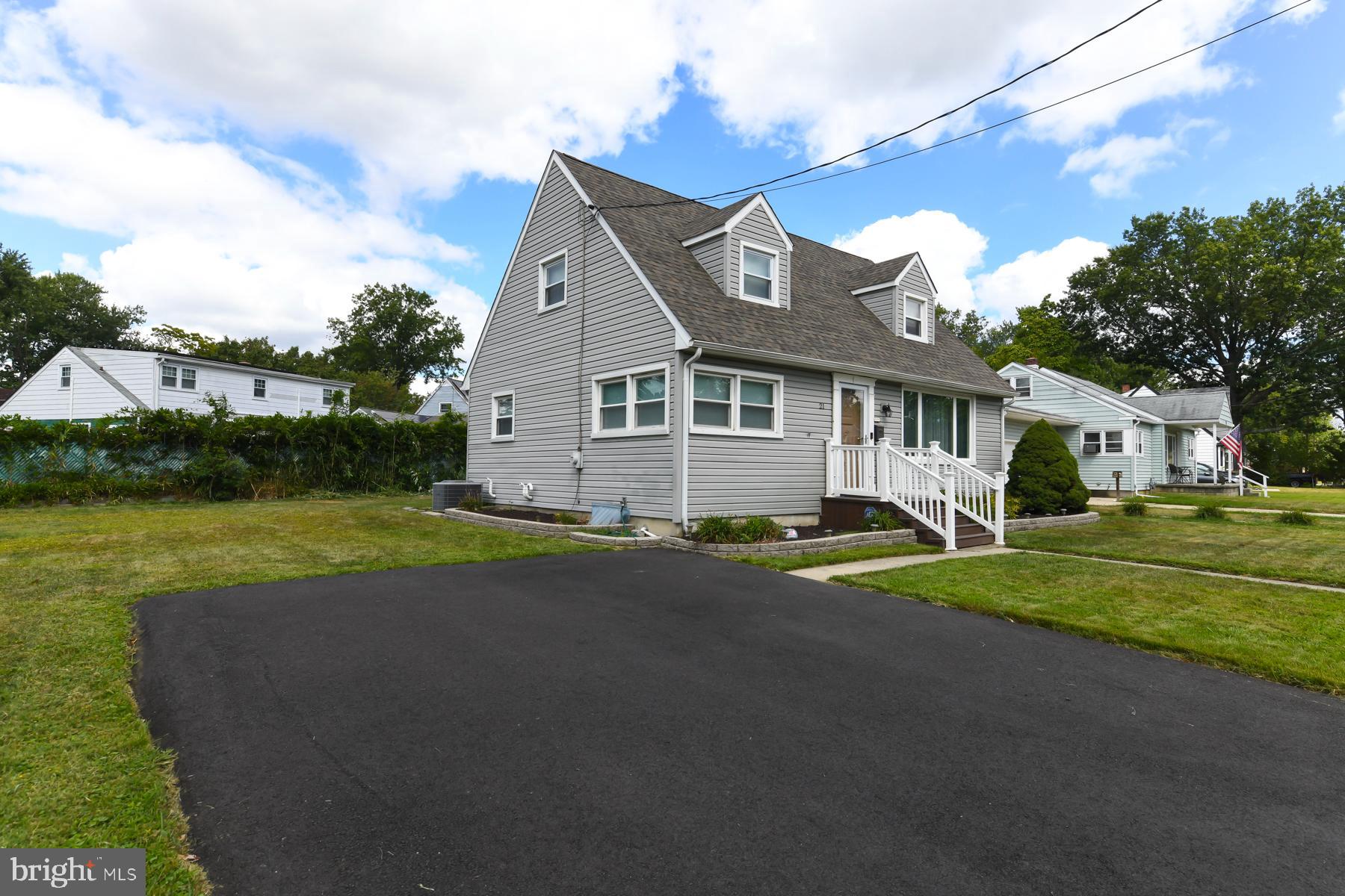 21 Hiawatha Road Somerdale, NJ 08083 - Photo 3 of 22 a view of a white house with a big yard and potted plants