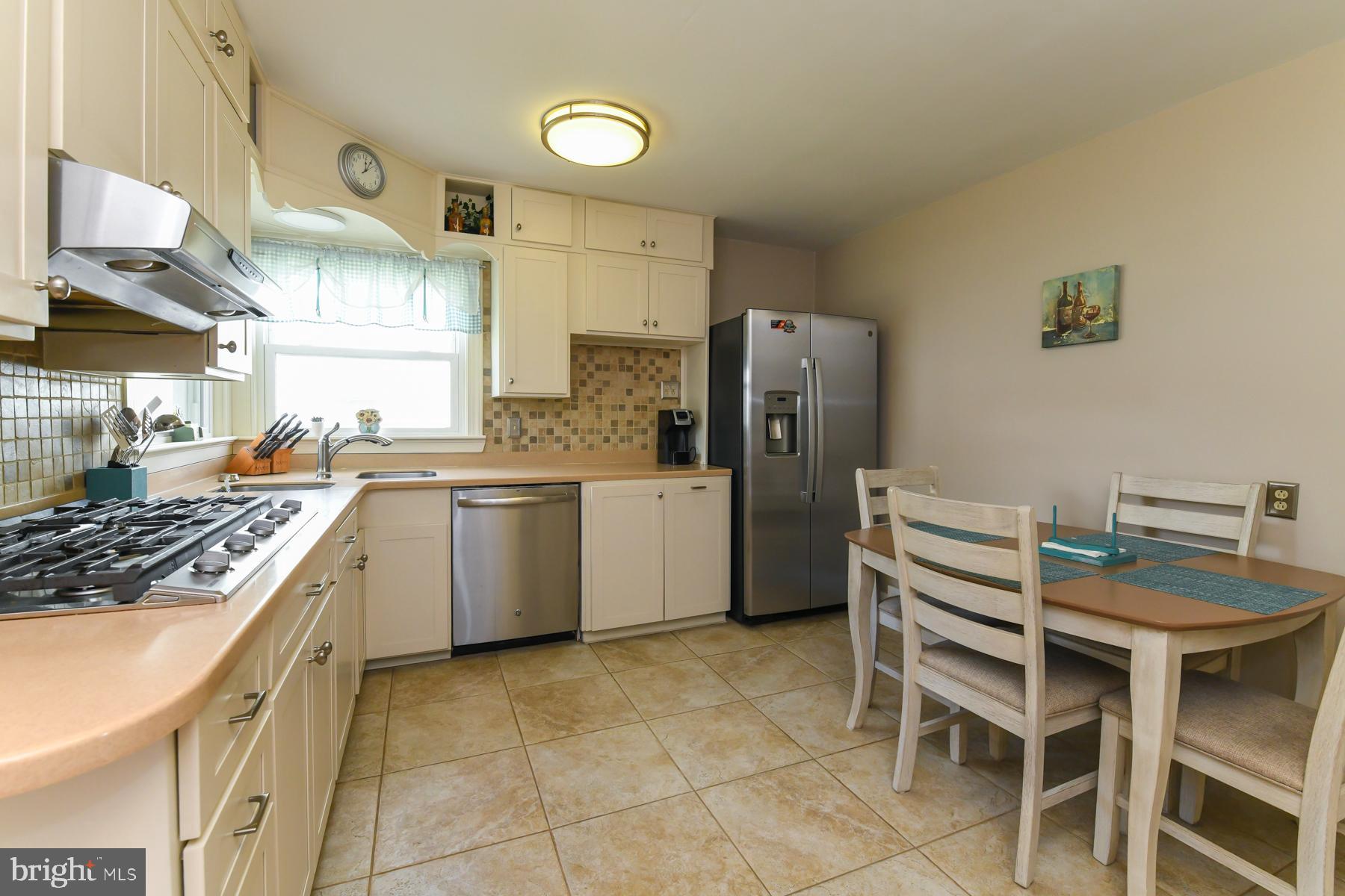 21 Hiawatha Road Somerdale, NJ 08083 - Photo 8 of 22 a kitchen with a stove a sink refrigerator and a stove