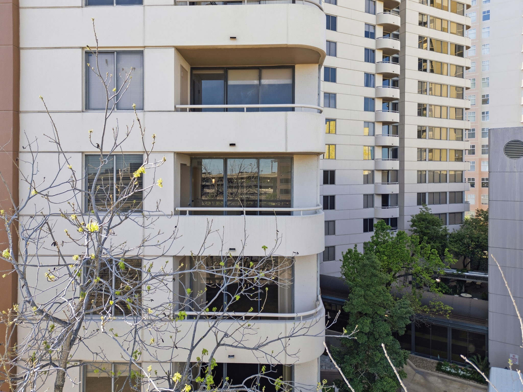 3525 Sage Road, Unit 504 Houston, TX 77056 - Photo 15 of 18 Look at those large windows! This view shows off the private balconies and floor-to-ceiling glass that bring tons of natural light into the living spaces.