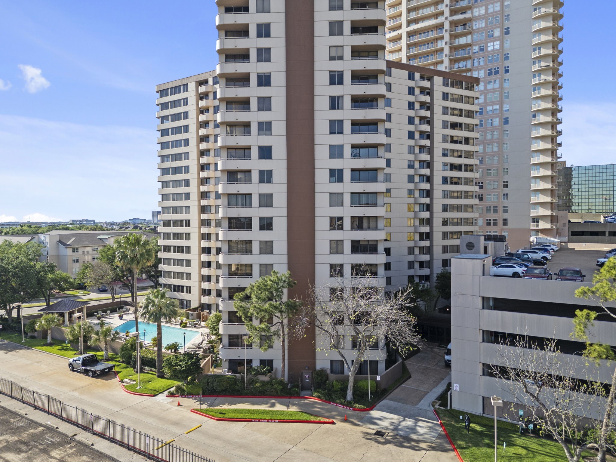 3525 Sage Road, Unit 504 Houston, TX 77056 - Photo 16 of 18 This angle shows how the building is perfectly set up for summer relaxation with plenty of lounge space and palm trees.