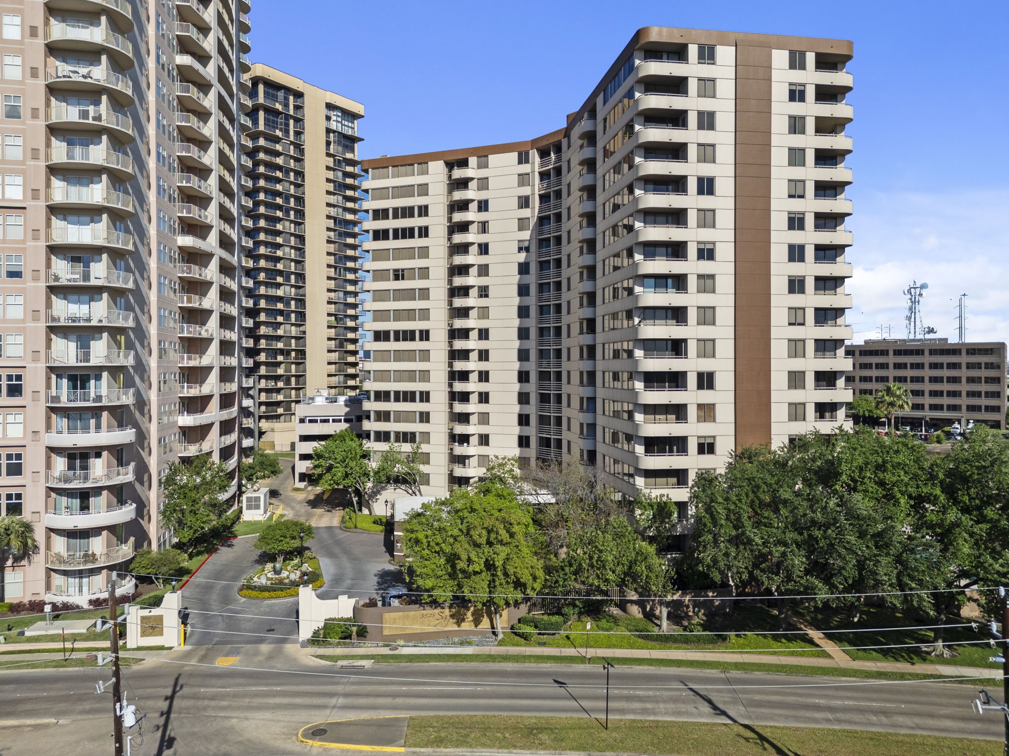 3525 Sage Road, Unit 504 Houston, TX 77056 - Photo 17 of 18 High-rise living at its finest! This shot shows the impressive scale of the building and how close you are to the heart of the city while still having plenty of green space around you.