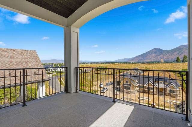 115 East Hidden Ridge Lane, Unit 42 Mapleton, UT 84664 - Photo 54 of 103 Covered balcony featuring a wood-finish ceiling, arched opening, and wrought iron railings