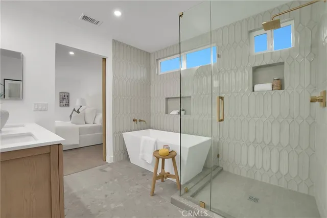 a bathroom with a tub a sink and a shower