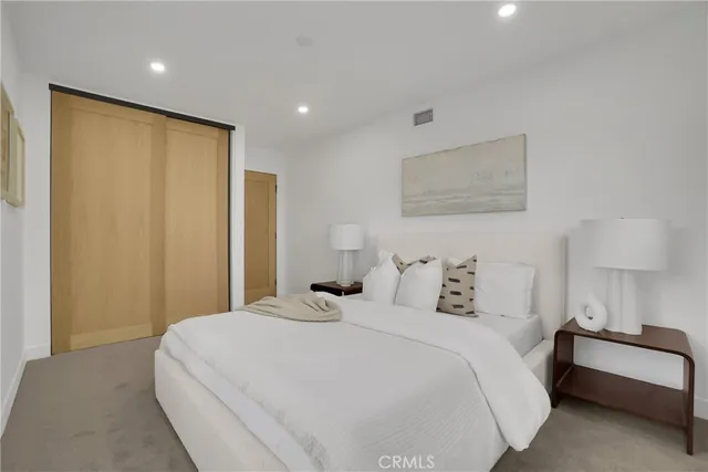 a bedroom with a bed and a night stand