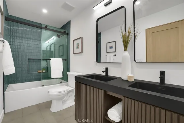 a bathroom with a sink toilet and mirror