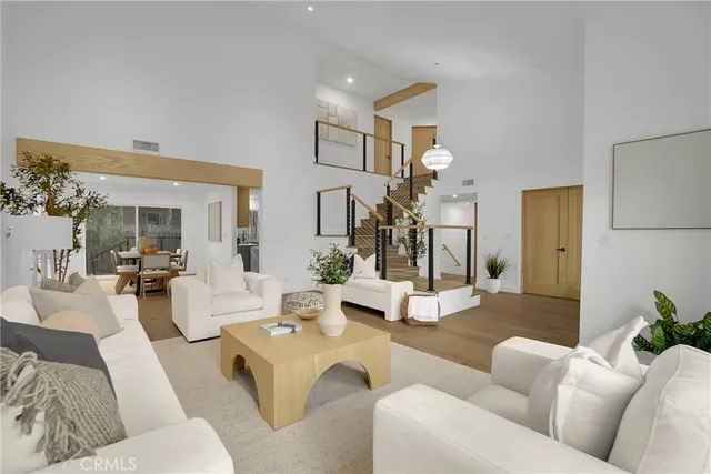 a living room with furniture flowerpot and a chandelier