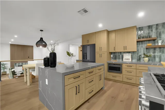 a kitchen with counter top space cabinets and stainless steel appliances
