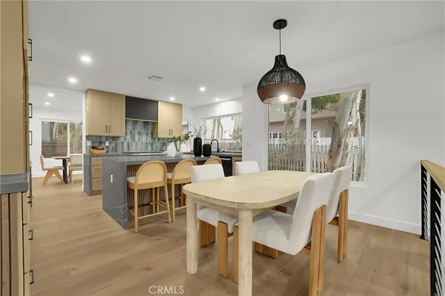 a dining room with furniture a chandelier and wooden floor