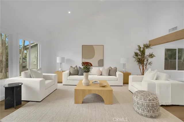 a living room with furniture lamp and a large window