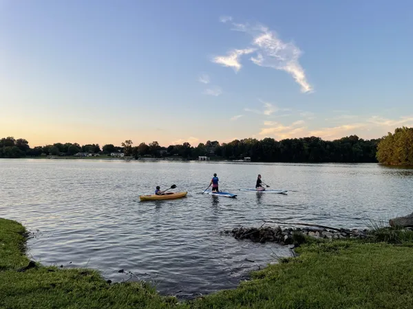 a view of a lake with houses in the back