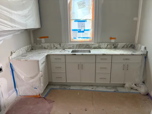 a bathroom with a granite countertop sink and vanity