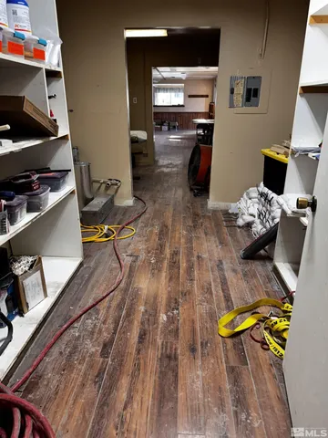 a room with gym equipment and wooden floor
