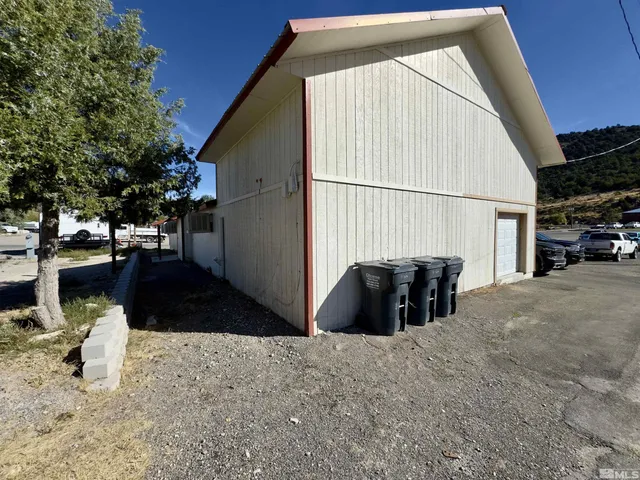 a view of a city street with couple of cars parked in parking lot