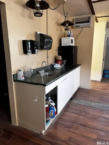 a kitchen with stainless steel appliances a microwave a stove and wooden floor