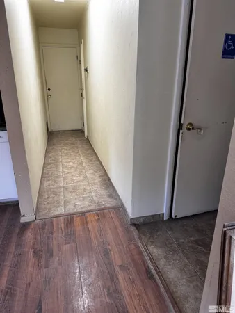 a white toilet sitting next to a white cabinet