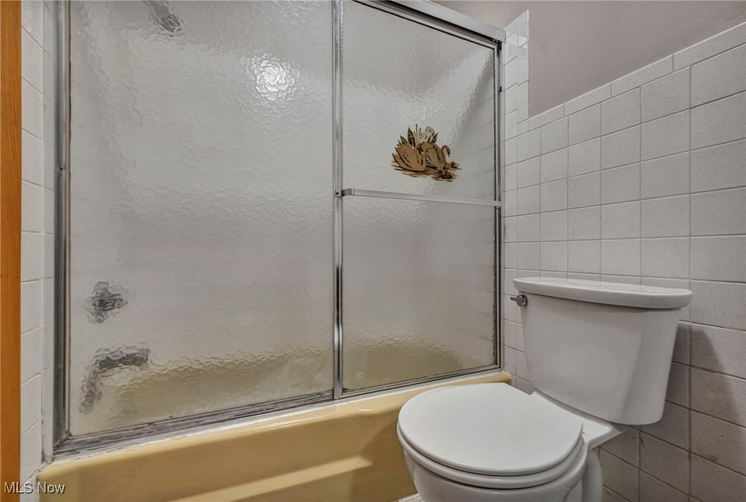 1140 Keefer Road Girard, OH 44420 - Photo 18 of 49 Bathroom with tile walls and bath / shower combo with glass door