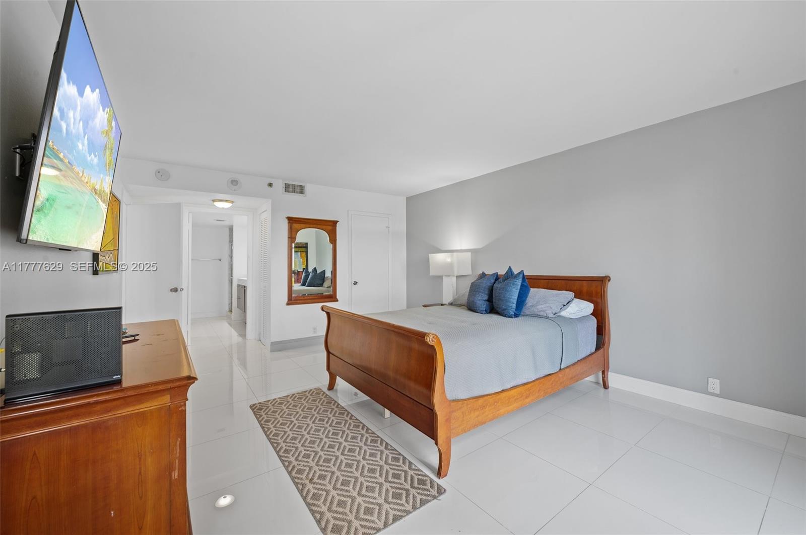 2000 Towerside Terrace, Unit 805 Miami, FL 33138 - Photo 15 of 47 a bed room with a bed and a couch