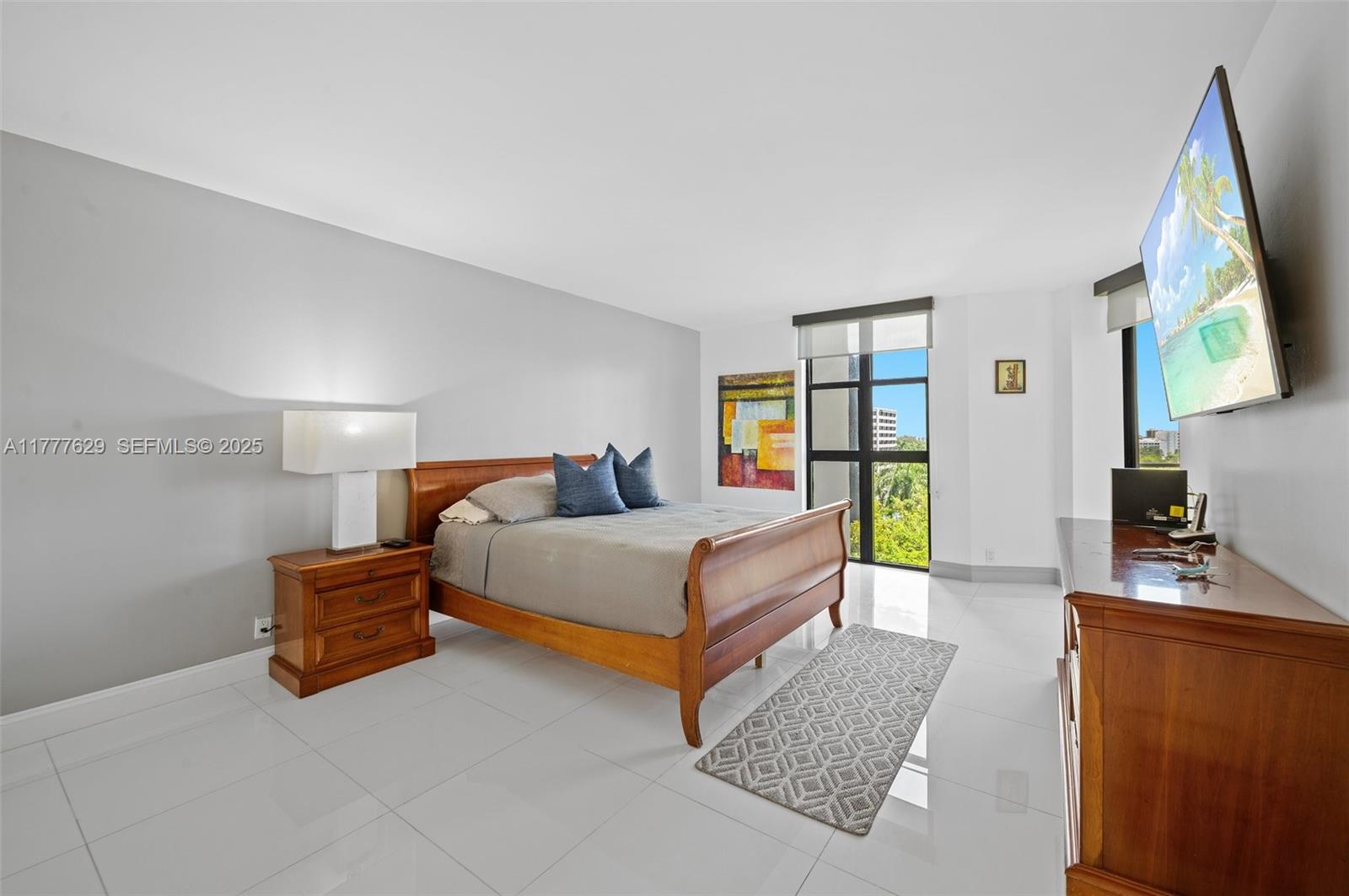 2000 Towerside Terrace, Unit 805 Miami, FL 33138 - Photo 16 of 47 a bedroom with a bed lamp closet and window