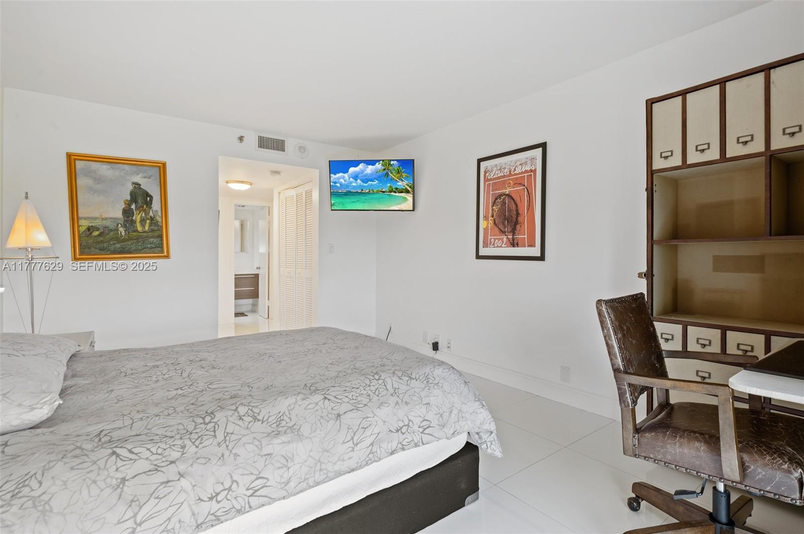2000 Towerside Terrace, Unit 805 Miami, FL 33138 - Photo 20 of 47 a bedroom with a bed and a table in it