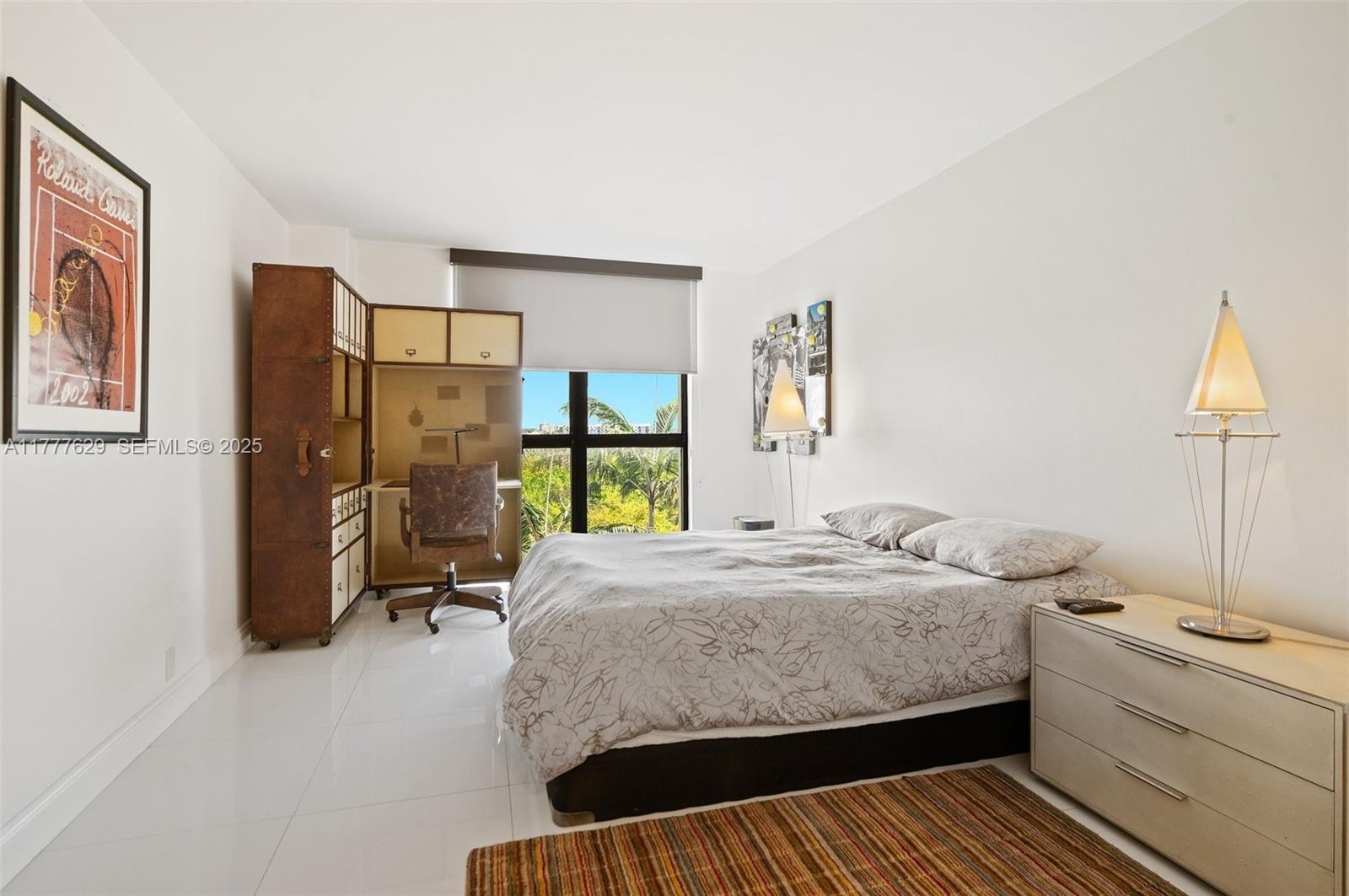 2000 Towerside Terrace, Unit 805 Miami, FL 33138 - Photo 21 of 47 a bedroom with a bed and wooden floor