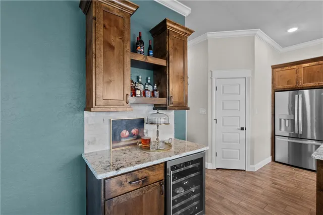 a kitchen with stainless steel appliances granite countertop a refrigerator and a sink