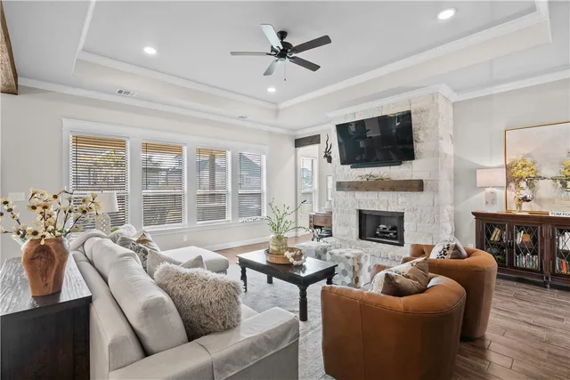 a living room with furniture a fireplace and a flat screen tv