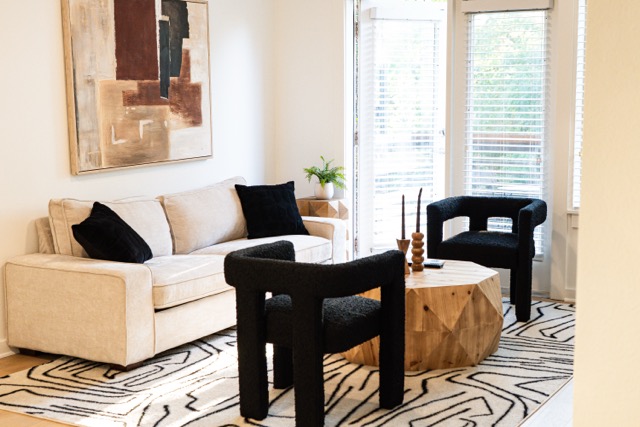 a living room with furniture and wooden floor