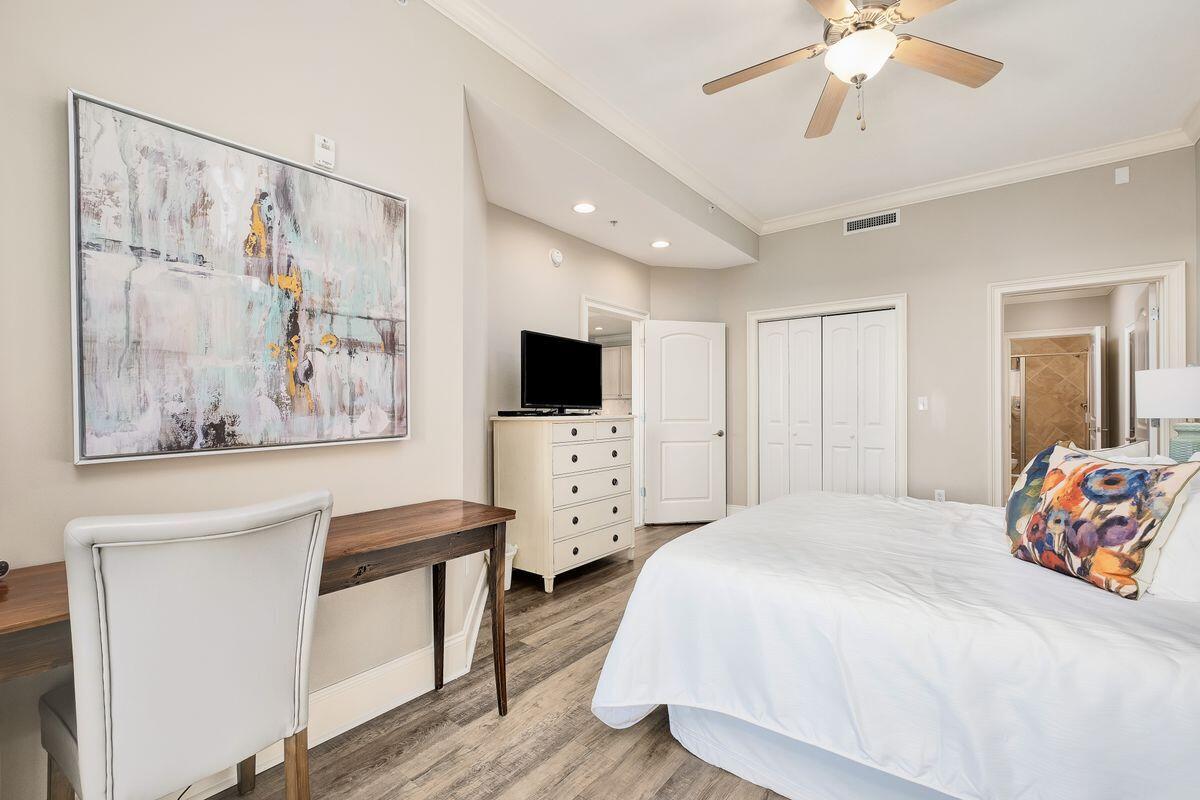 2421 West County Highway 30A, Unit E305 Santa Rosa Beach, FL 32459 - Photo 12 of 39 a spacious bedroom with a bed and a flat screen tv
