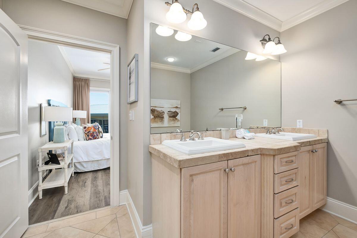 2421 West County Highway 30A, Unit E305 Santa Rosa Beach, FL 32459 - Photo 13 of 39 a bathroom with a double vanity sink and a mirror