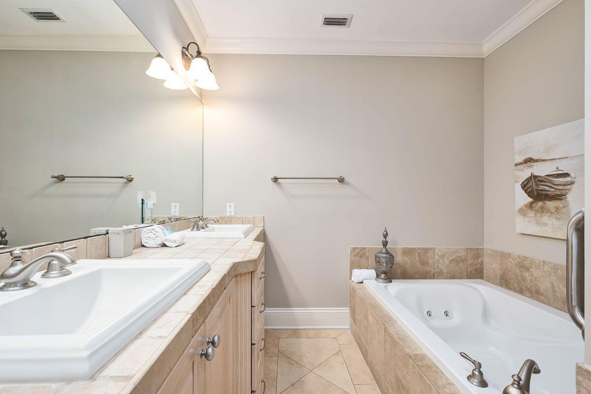 2421 West County Highway 30A, Unit E305 Santa Rosa Beach, FL 32459 - Photo 15 of 39 a bathroom with a tub a double vanity sink and mirror