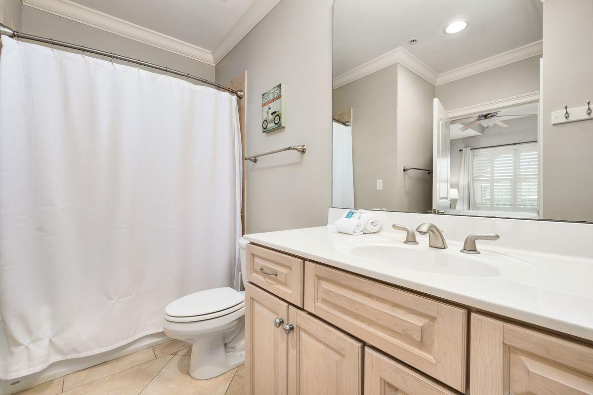 2421 West County Highway 30A, Unit E305 Santa Rosa Beach, FL 32459 - Photo 19 of 39 a bathroom with a sink a toilet and a mirror