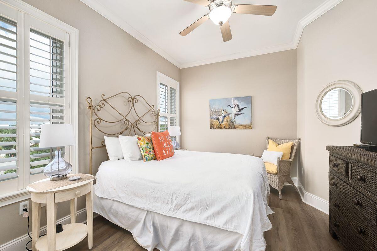 2421 West County Highway 30A, Unit E305 Santa Rosa Beach, FL 32459 - Photo 20 of 39 a bedroom with a bed and a chandelier