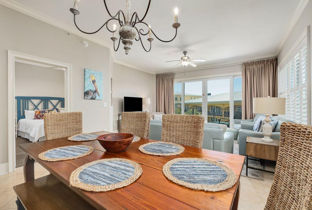 2421 West County Highway 30A, Unit E305 Santa Rosa Beach, FL 32459 - Photo 2 of 39 a view of a dining room with furniture wooden floor and chandelier