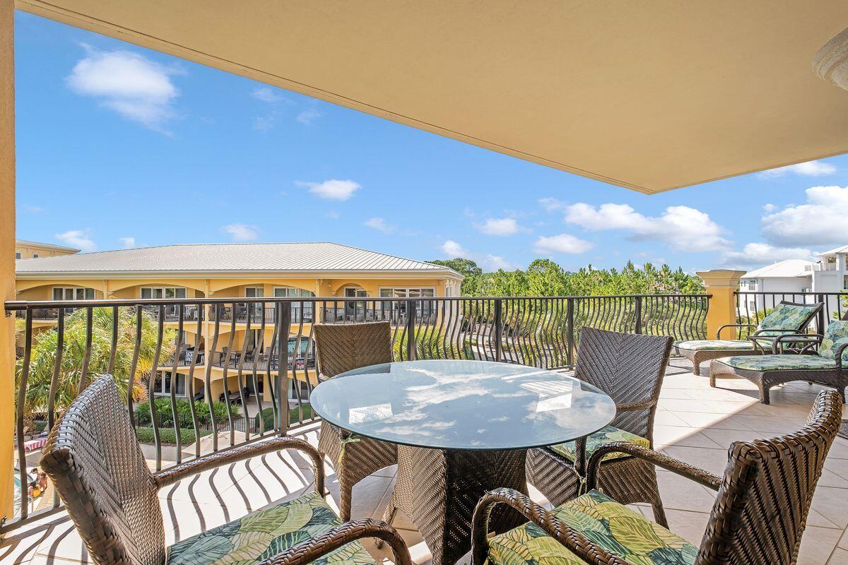 2421 West County Highway 30A, Unit E305 Santa Rosa Beach, FL 32459 - Photo 30 of 39 a view of a patio with a table and chairs