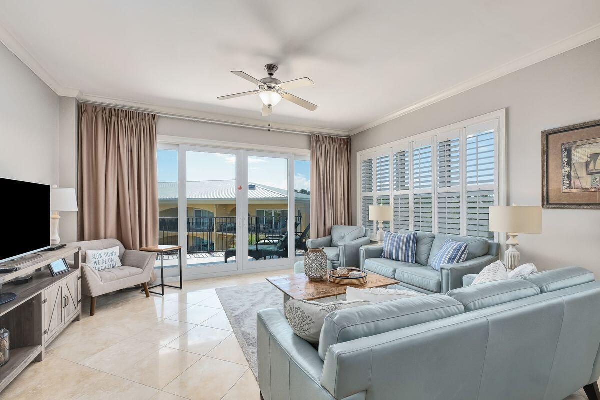 2421 West County Highway 30A, Unit E305 Santa Rosa Beach, FL 32459 - Photo 3 of 39 a living room with furniture and a flat screen tv