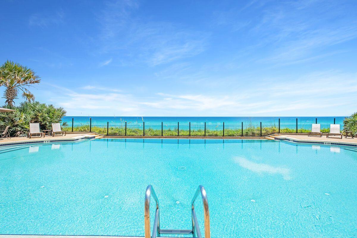 2421 West County Highway 30A, Unit E305 Santa Rosa Beach, FL 32459 - Photo 35 of 39 a view of swimming pool with outdoor seating and lake view