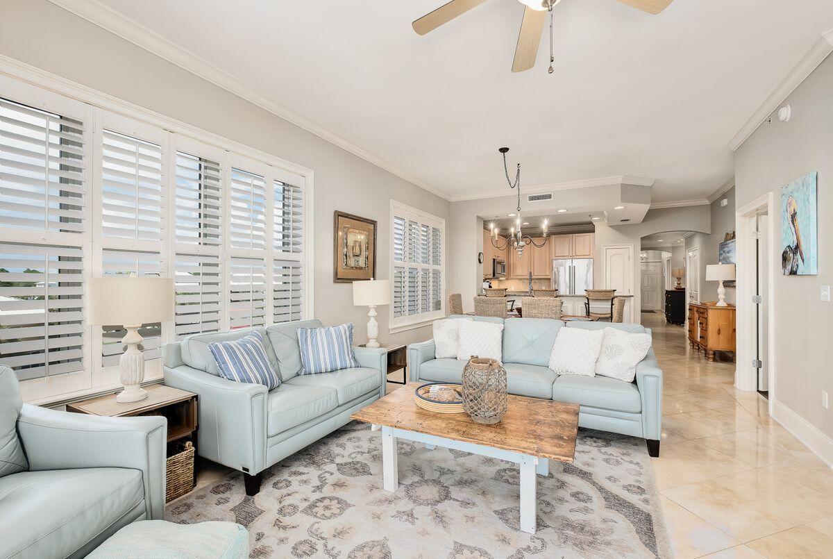 2421 West County Highway 30A, Unit E305 Santa Rosa Beach, FL 32459 - Photo 5 of 39 a living room with furniture dining area and a chandelier